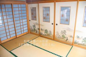 an empty room with a painting on the wall at 民泊よこてこよ in Yokote +24 photos