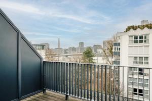 a balcony with a view of a city at The Dean Munich, Autograph Collection in Munich