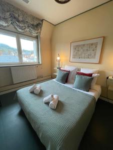 a bedroom with two swans towels on a bed at Logis Hotel Le Relais du Quercy in Meyssac