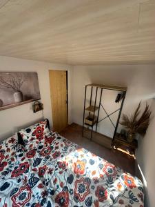 a bedroom with a bed and a mirror at Vakantiehuis chaletje in Lanaken