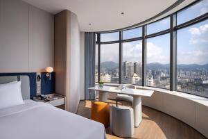 a hotel room with a bed and a desk at NOVOTEL Zhoushan Luting in Zhoushan +78 photos
