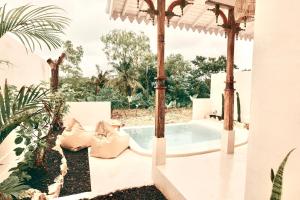 a pool in a backyard with a pergola at Romantic private villas Buvillas nusa penida in Nusa Penida