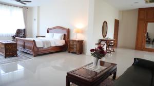 a bedroom with a bed and a vase of flowers on a table at Three Kings Private Luxury Villa in Chiang Mai +35 photos