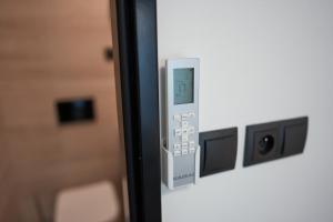 a close up of a remote control on a door at Mondeso Hotel in Aš +21 photos