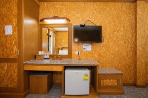 a bathroom with a vanity with a tv on the wall at Chatsuree Boutique Resort in Ubon Ratchathani +54 photos
