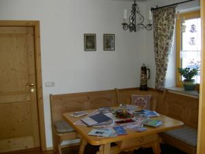 a room with a wooden table with books on it at Fewo Bergruah in Bad Bayersoien