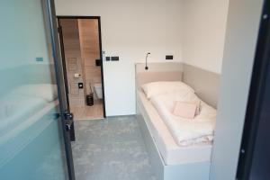 a small room with a bed and a mirror at Mondeso Hotel in Aš