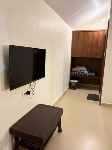 a living room with a flat screen tv on the wall at Palm Paradise Resort in Revadanda