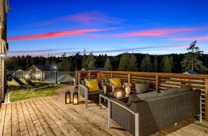 a patio with a couch and chairs on a deck at Modern apartment with two bedrooms in Hektner