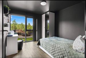 a bedroom with a bed and a large window at Modern apartment with two bedrooms in Hektner