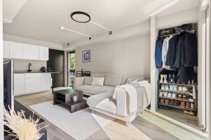 a living room with a couch and a closet at Modern apartment with two bedrooms in Hektner