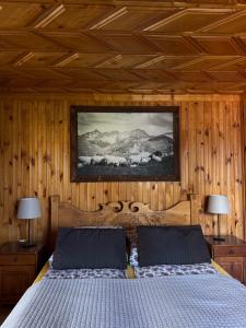 a bedroom with a bed in a wooden wall at Willa Karolina Centrum Zakopane in Zakopane