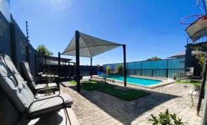 a patio with a swimming pool and a pavilion at Day&Night Stay in Johannesburg