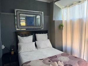 a bedroom with a bed with a mirror above it at Day&Night Stay in Johannesburg +35 photos