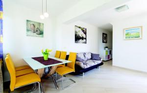 a living room with a table and yellow chairs at Apartment Vilic in Pula