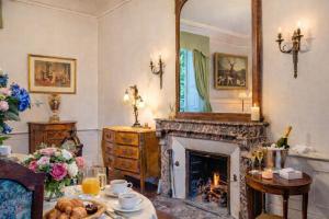 a living room with a fireplace and a mirror at Chateau d'Isigny - Normandie - Country House in Isigny-le-Buat