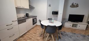 a small kitchen with a small table and a television at Stiller Hafen in Herbolzheim