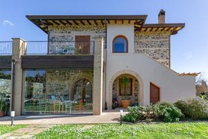 a house with a balcony on top of it at Casale Elisa Country Hotel in Ladispoli