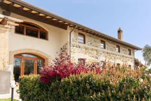 a stone house with flowers in front of it at Casale Elisa Country Hotel in Ladispoli +83 photos
