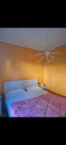 a bedroom with a large bed with a ceiling fan at Gg Home in Sirmione
