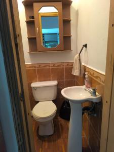 a bathroom with a toilet and a sink at Marbyn & Ana House in Tegucigalpa +2 photos