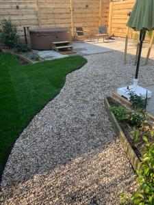a garden with a gravel walkway and a patio at Onder de Oude Walnoot in Sint Pancras