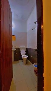 a bathroom with a toilet and a sink at Hotel Preet La Casa in Thānesar