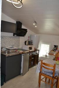 a kitchen with a sink and a counter top at studio indépendant dans maison à la campagne in Égliseneuve-près-Billom