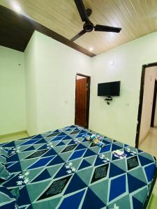 a bedroom with a blue and white tiled bed at Hotel Preet La Casa in Thānesar