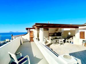 a balcony of a house with a table and chairs at CasaEolia Blues in Canneto