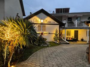 a house with christmas lights in the yard at VILLA MARIA Požega in Požega
