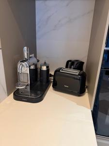 a coffee maker and toaster sitting on a counter at Maison moderne in Saint-Julien-de-Concelles