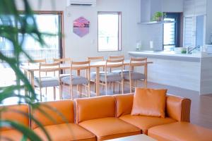 a living room with a couch and a table and chairs at Links Seaside resort in Futtsu
