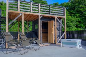 a small house with chairs and a table and a bench at Links Seaside resort in Futtsu