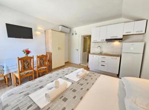 a living room with a kitchen and a dining room at Adriatic Guesthouse Balota with Shared Pool in Viganj