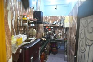 a small kitchen with a counter and a sink at 3 Sixty House in Bodh Gaya +33 photos