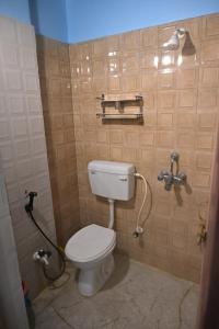 a bathroom with a white toilet in a room at 3 Sixty House in Bodh Gaya