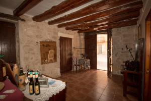 a room with a table with wine bottles on it at Cal Manyo in Puigvert de Lérida