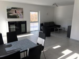 a living room with a table and chairs and a couch at Bett & Bike Eden in Senftenberg