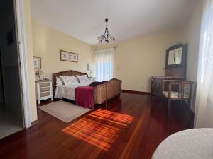 a bedroom with a bed and a table and a mirror at leiradaporta in Monforte de Lemos +34 photos
