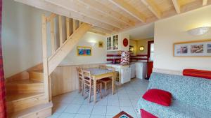 a room with a bed and a kitchen with a table at La Maison du Carbonet in Batz-sur-Mer