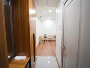 a hallway leading to a dining room with a table at Premiere Hotel Tashkent Pool&Spa in Tashkent