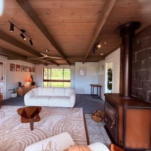 a living room with a fireplace and a couch and a stove at Southern Grampians Lookout in Dunkeld +20 photos