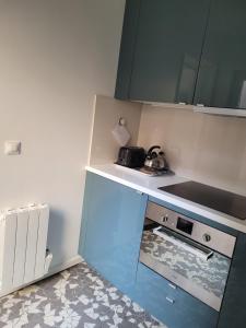 a small kitchen with a stove top oven in it at La maison de toujours in La Garenne-Colombes +19 photos