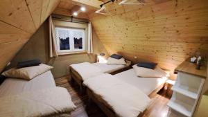 a room with three beds in a log cabin at Ferienhaus Rita in Bad Bocklet