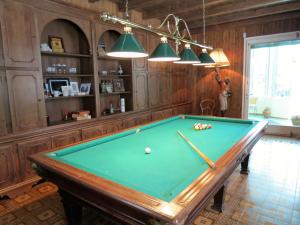 a pool table in a room with wood paneling at Villa Morissolina in Trarego