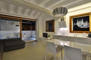 a dining room and living room with a table and chairs at Lonja Suites Apartments in Palma de Mallorca