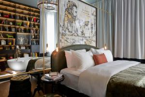 a bed room with a large bed and a painting on the wall at Sir Savigny Hotel in Berlin