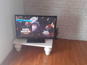 a television sitting on a white table in a room at Villa Ivan Vodice in Vodice