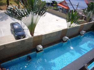 an overhead view of a swimming pool with a car at Chic Condominium Unit A303, A306, A307, A308, A406 in Karon Beach